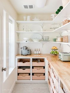 the kitchen is clean and ready to be used for cooking or baking, with baskets on the counter