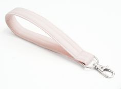 a white lanyard with a metal hook on it's end and a light pink strap