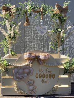 a wooden crate with some plants in it and a sign that says we can wait