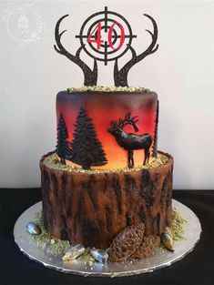 a cake decorated with deer and pine trees