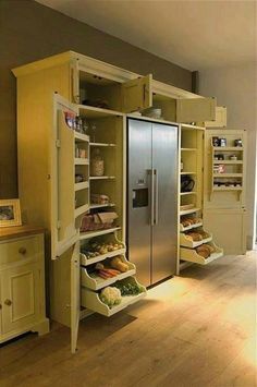 an image of a refrigerator in the middle of a room with shelves full of food