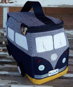 a blue and white checkered bag sitting on top of a wooden bench