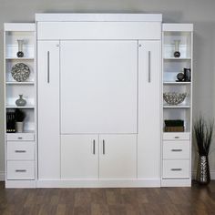 a white bookcase with two doors and three drawers on each side in front of a wooden floor