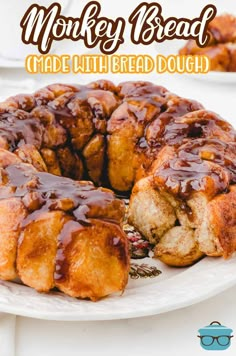 a monkey bread cake on a white plate with chocolate sauce drizzled over it