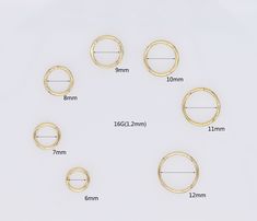 six pairs of gold plated metal rings size guide on white background with measurements for each ring