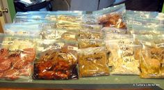 several bags of food sitting on top of a counter next to another bag filled with meat