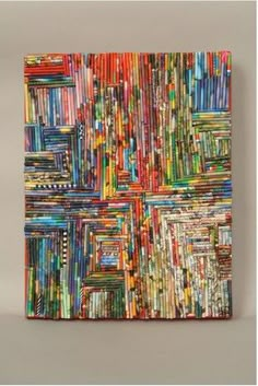 an abstract painting with many different colors and patterns on the canvas, hanging on a wall