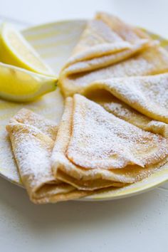 a plate with lemons and powdered sugar on it