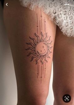 a woman's thigh with a sun and stars tattoo on it