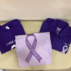 April Is Sarcoidosis Awareness Month! Help To Spread The Awareness Of This Disease In Your Community By Wearing These Purple T-Shirts To Show Your Support! Get All 3 Shirts For One Low Price! 2 T-Shirts - One Purple, One Light Purple And One Purple Polo Shirt. All Shirts Are New, Unworn, Size Xl Unisex And All Shirts Say, "I Am An Unstoppable Warrior" On The Front With A Ribbon Logo. Back Of Polo Shirt Has The Logo For Fsr (Foundation For Sarcoidosis Research). Back Of Both T-Shirts Say: Warrior Purple Casual Top For Awareness Events, Casual Purple Top For Awareness Events, White Cotton Tops For Awareness Events, Casual Cotton Shirt For Awareness Events, Purple T-shirt For Awareness Events With Letter Print, Purple T-shirt With Letter Print For Awareness Events, Purple Polo Shirt, Ribbon Logo, Purple T Shirts