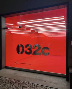 an empty red glass store front with the number 350 on it's display window