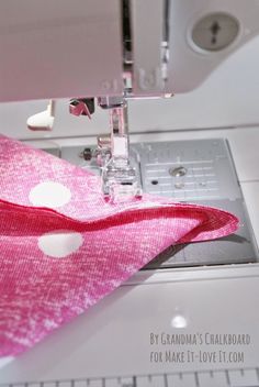 a sewing machine with a pink and white polka dot fabric on it's side