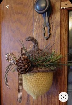 a pine cone hanging from the side of a door