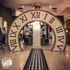 an entrance to a store with roman numerals on the front and back walls