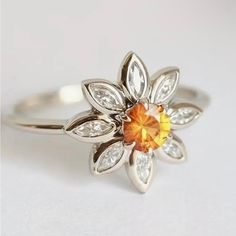 an orange and white diamond flower ring