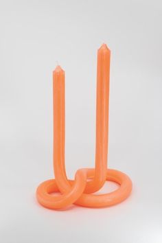 two orange candles sitting on top of each other