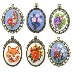 four different types of embroidered pendants with flowers on them