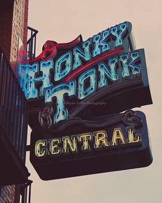 a neon sign that reads honey honk tonk central