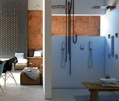 a dining room table and chairs in front of a shower