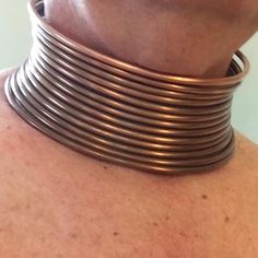 This authentic tribal style neck coil comes to you ready to form in place for a dramatic lifestyle look.  This solid copper neckpiece is a true replica of the traditional neck coils (Idzilla) made famous by natives of Africa and Southeast Asia. Just like the originals this neckpiece requires some effort to fit correctly using traditional forming techniques. Once in place this neck coil can remain as long as you like. Comfortable, durable, and distinctive the inventors of this style wear these neck coils for extended periods. No snaps, no hinges, no pins, no plastic, no nonsense, no kidding. Medium weight soft copper wire is the real thing. Massive yet comfortable once in place.  Each piece is formed in 15" circumference circular shape as shown in photos. The coil is shipped to you in an ex