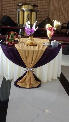 a table with purple and gold cloth on it