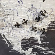 a map with airplanes flying over it and the united states in black and white colors