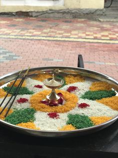 a platter filled with food on top of a table next to a brick sidewalk