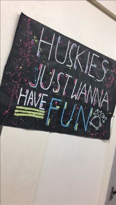 a sign hanging on the wall that says huskies just wanna to have fun