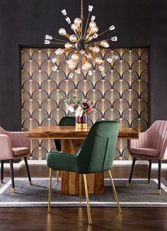 a dining room table with green chairs and a chandelier