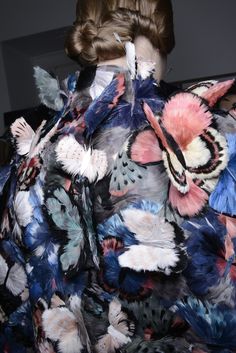 a bunch of butterflies that are on top of a table with some kind of cloth