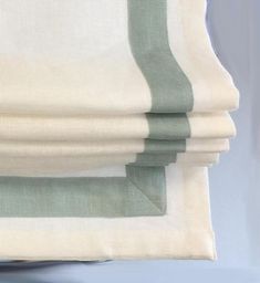 three folded sheets with green and white stripes on them