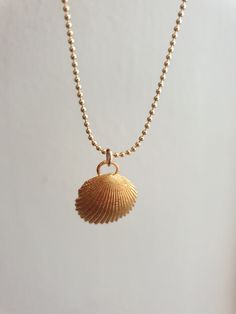 A sea shell necklace made of natural shells casted in brass and plated with quality, nickel free 14k gold plating. The necklace is made of 14k gold filled. Handmade Gold Ocean-inspired Charm Necklaces, Handmade Ocean-inspired Gold Charm Necklaces, Delicate Gold Necklace For Beach, Ocean-inspired Gold Shell Charm Necklaces, Dainty Gold Shell Charm Necklace, Ocean-inspired Gold Shell Charm Necklace, Dainty Gold Shell-shaped Necklace, Dainty Gold Shell Jewelry, Necklace Gold Pendant