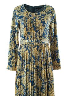 Experience the mesmerizing design and exude effortless elegance with the Navy and Gold Henna print silk chiffon maxi dress. The subtle pleats, accompanied by a full lining and a belt, will uplift your spirits. Suitable for all occasions, simply hand wash this 59-inch dress for convenient maintenance.