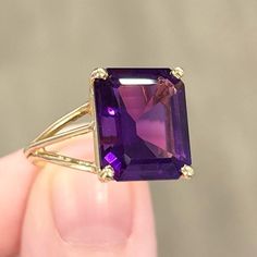 Large Stunning Mid-Century Style Solitaire Ring! Featuring A Gorgeously Deep, Dark Hued 14x12mm Emerald Cut Purple Amethyst, Set In 14k Solid Yellow Gold. Unmarked, But Acid Tested As 14k Solid Gold. This Ring Is A Size 7.25 This Ring Weighs 5.96g This Ring Measures 2.5mm From The Back Of The Band. Vintage Condition: Very Good (Some Minor Wear On The Setting; Very Minor Surface Scratches On The Stone). Classic Purple Rings With Prong Setting, Elegant Purple Amethyst Birthstone Ring, Formal Purple Amethyst Birthstone Ring, Timeless Purple Jewelry For Formal Occasions, Purple Amethyst Birthstone Ring For Formal Occasions, Timeless Purple Rings Perfect For Gifts, Purple Amethyst Ring For Anniversary, Timeless Purple Rings As Gifts, Timeless Purple Rings For Gifts