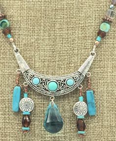 "Boho Turquoise Natural Stone Jewelry Set. Necklace and Earrings. Sw. Austrian Crystal Large Turquoise Drop on Necklace Focal. Earrings with Beaded Tassels. Magnetic Rhinestone Clasp. Jesse James Beads * Sw. Austrian Crystal Large focal drop *Turquoise  *Boho *Rhinestone Magnetic Clasp  *Necklace 18\" *Beaded Tassels *Turquoise Natural Stone *Necklace $45.00 *Earrings $15.50" Turquoise Costume Jewelry With Dangling Beads, Turquoise Dangling Beads Costume Jewelry, Bohemian Turquoise Jewelry Sets For Gifts, Adjustable Turquoise Bohemian Jewelry Sets, Bohemian Turquoise Dangle Jewelry, Bohemian Teardrop Turquoise Jewelry, Handmade Bohemian Turquoise Jewelry Sets, Handmade Turquoise Bohemian Jewelry Sets, Turquoise Teardrop Bohemian Jewelry