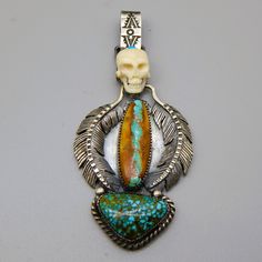 "Be noticeable with the jewelry you wear, buy only unique Excellent handmade sterling silver bone carved scull, set with Royston and Number 8 turquoise \" Scull and Feathers \" pendant, 3.5\" tall. Available at $264.00 ( retail is $577.00 )." Bohemian Carved Sterling Silver Jewelry, Artisan Carved Jewelry For Collectors, Artisan Carved Jewelry For Collectibles, Bohemian Sterling Silver Skull Jewelry, Unique Skull-shaped Collectible Jewelry, Unique Skull Shaped Collectible Jewelry, Turquoise Carved Bohemian Jewelry, Bohemian Carved Turquoise Jewelry, Bohemian Turquoise Carved Jewelry