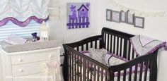 a baby crib with purple and white decor