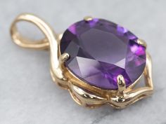 This amethyst gem is bursting with brilliant purple color! The oval cut faceting optimizes its luster, and the shining warm gold only compliments the stone with its deep violet hue. This pendant could be worn every day or for special occasions!!This pendant does not come with the chain shown. Please feel free to contact us, we will help you find the perfect chain for your style and budget!Metal: 14K Yellow GoldGem: Amethyst 3.96 CaratsGem Measurements: 12.0 x 10.0 mm, OvalMeasurements: 23 x 13 mm, with bailMarks: "14K" Stamped on the bail Amethyst Gem, Solitaire Pendant, The Shining, Amethyst Pendant, February Birth Stone, New Hampshire, Purple Color, Jewelry Necklace Pendant, Amethyst