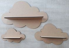 three pieces of cardboard cut out to look like clouds