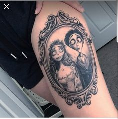 a woman's leg with a mirror on it that has an image of two people in the frame