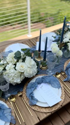 the table is set with blue and white flowers