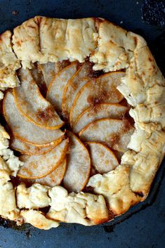 an apple pie with slices cut out on it's side, sitting in a pan