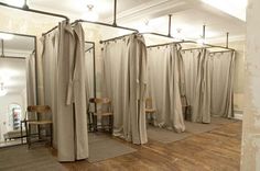 a room filled with lots of white curtains