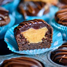 chocolate cupcakes with peanut butter frosting on blue paper plates lined up in rows