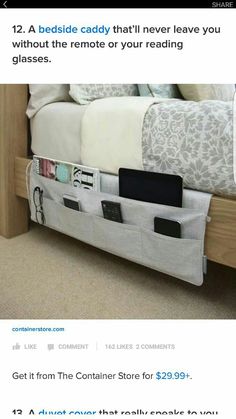 a bed with an attached storage pocket on the bottom and two phone holders in it