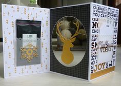 an open card with a deer and snowflake on it, in front of a box