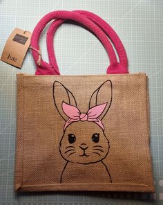 Jute bag for the little ones, with a flock foil print of a cute bunny on one side and a name on the other side. Are you looking for a special bag for your child that is not only practical and durable, but also personal and unique? Then our personalized jute bag could be just the thing for you! This beautiful bag made from sturdy jute material is not only eco-friendly and sustainable, but also printed with a cute bunny motif on one side and your child's name on the other side. This means your chi Cute Bunny Design Bags For Everyday Use, Cute Bunny Design Bag For Everyday Use, Cute Everyday Bags With Bunny Design, Cute Pink Bunny Design Bags, Cute School Bag With Bunny Design, Small Bunny, Handpainted Bags, Jute Bag, Top Handle Bags