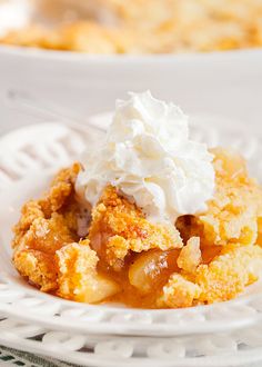 a close up of a plate of food with whipped cream on top