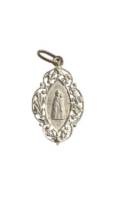 This is an antique  religious medal, depicting Our Lady of Chevremont, made of sterling silver. The Chapelle of the English Jesuits or Our Lady of Chevremont is a small Catholic religious building on the hill of Chevremont. Built in the 17th century by English Jesduits in exile in the Principality of Liège, the chapel became a center of Marian worship and pilgrimage. Increasing numbers of pilgrims led, at the end of the19th century, to the construction the great basilica. It is in good antique c Engraved Coin-shaped Spiritual Jewelry And Charms, Engraved White Gold Jewelry For Commemoration, Miraculous Medal Pendant For Wedding, Wedding Miraculous Medal Pendant, Vintage Sterling Silver Miraculous Medal, Vintage Sterling Silver Miraculous Medal Jewelry, Silver Miraculous Medal For Wedding, Silver Miraculous Medal Jewelry For Wedding, Silver Gift Wrap