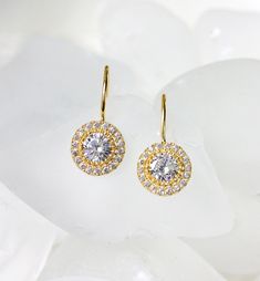 With intricate cubic zirconia details, these dainty drop earrings make a show-stopping statement for every special occasion. Lightweight and comfortable to wear for long periods. MATERIALS + MEASUREMENTS: - .925 Sterling Silver, 14K Gold or Rose Gold over Sterling Silver - Cubic Zirconia pave crystals - Height including hook 0.75 in (2 cm) x Width 0.4 in (1 cm) - Crystal Diameter 0.4 in (1 cm) - Hypoallergenic fish hook MATCHING JEWELRY ► Back Necklace NB053 - https://www.etsy.com/listing/537450 Cubic Zirconia Halo Earrings, Bridal Halo Design Cubic Zirconia Drop Earrings, Halo Design Cubic Zirconia Bridal Drop Earrings, Gold Bridal Earrings With Brilliant Cut Dangle, Halo Design Bridal Drop Earrings, Bridal Drop Earrings With Halo Design, Halo Dangle Earrings For Anniversary, Halo Round Cut Cubic Zirconia Earrings, Dainty Cubic Zirconia Earrings With Brilliant Cut